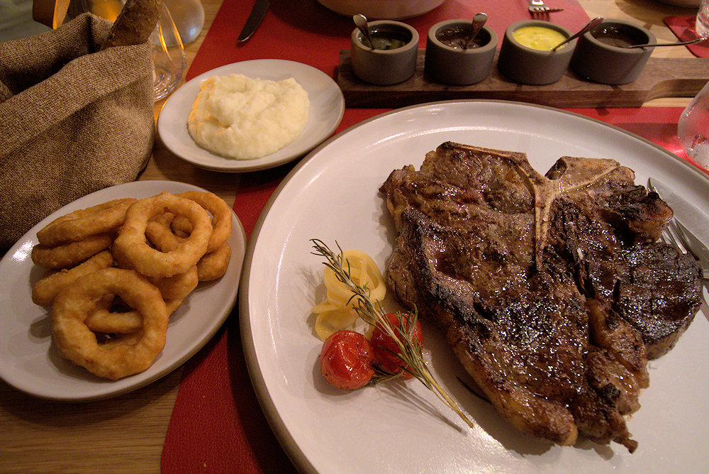 Porterhouse steak with onion rings at MSC Seaside steakhouse